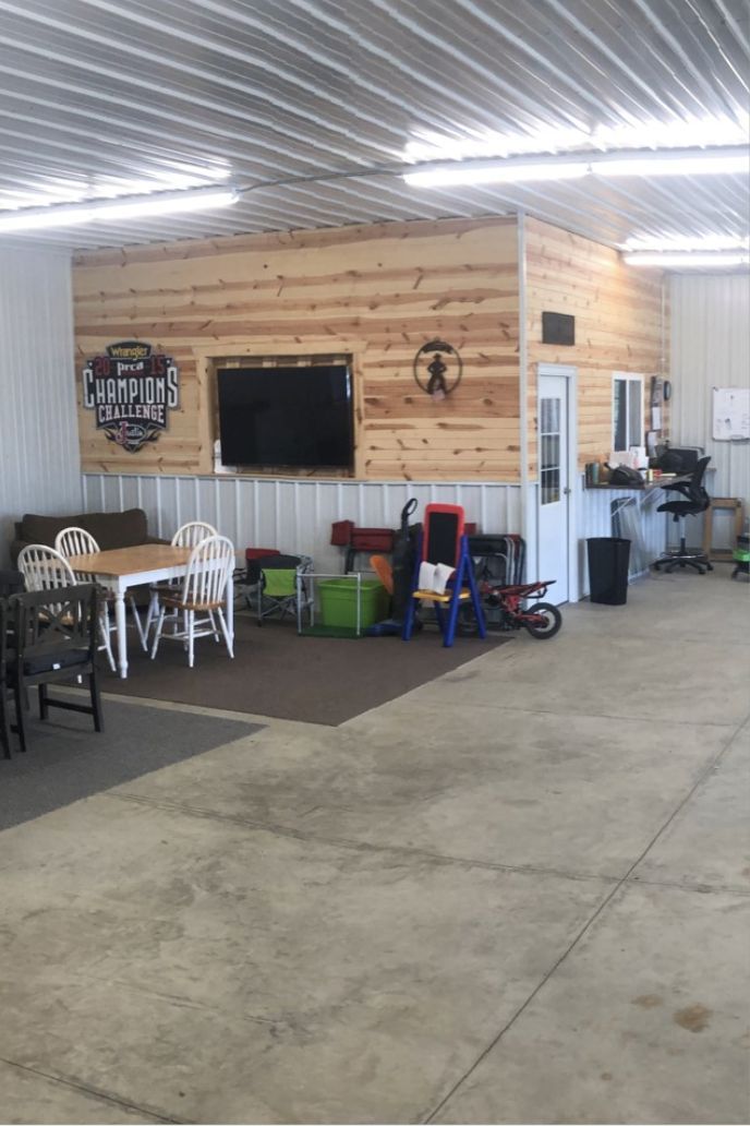 the inside of a garage with tables and chairs