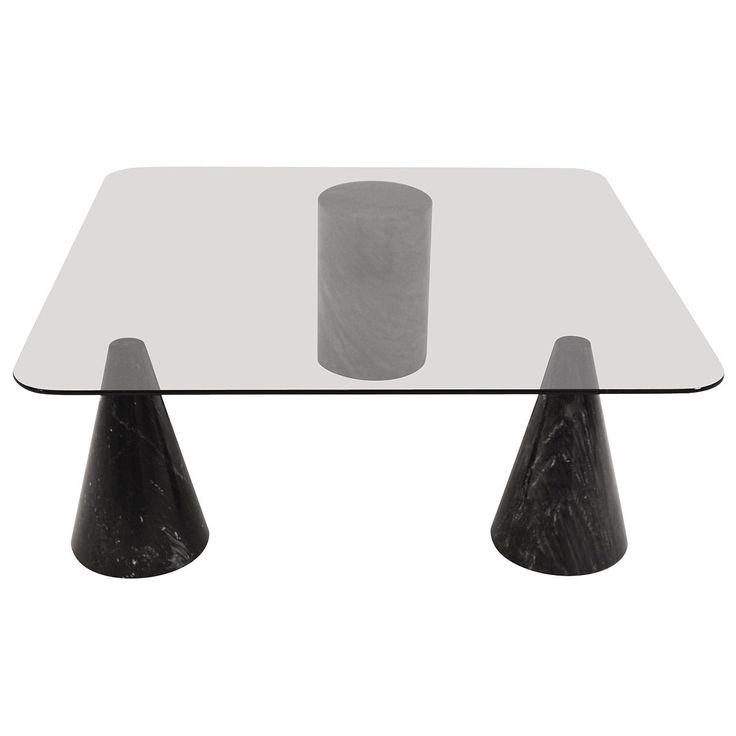 a glass and metal table with two black cones on the top, in front of a white background