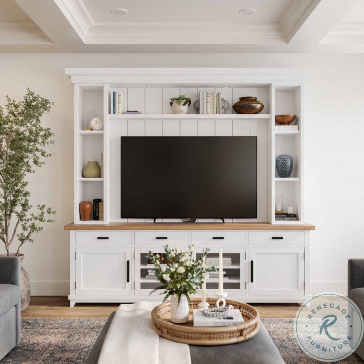 a living room filled with furniture and a flat screen tv on top of a white entertainment center