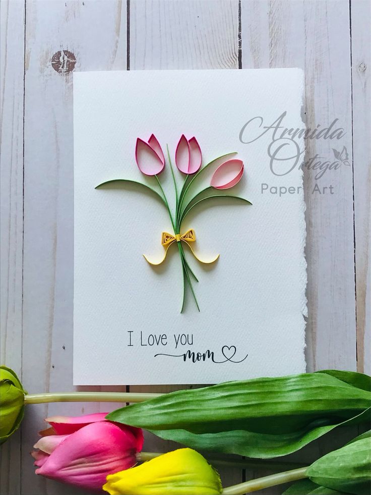 a card with some flowers on it and the words i love you mom written in gold