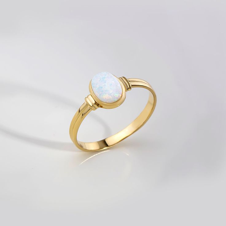 ABOUT PRODUCT  This 14K solid gold White  Opal Ring. The stackable ring is suitable for every finger, especially forefinger.  You can buy this trendy, minimalist ring as a birthday, anniversary, Valentine's Day or Mother's Day gift. It is also suitable as an engagement or promise ring for your girlfriend.  We produce and package our jewelry carefully for you. Our aim is to produce minimalist jewelry for daily use. If you want to add a special note we can write for you and put into the package. I Gold Oval Opal Ring Fine Jewelry, Oval Gold Opal Ring In 14k Gold, Oval Cabochon Opal Ring In White Gold, Oval Cabochon White Gold Opal Ring, Classic Opal Ring With Polished Oval Cabochon, Classic Opal Ring With Oval Cabochon And Polished Finish, Oval White Gold Opal Cabochon Ring, Fine Jewelry Oval Opal Ring With Polished Finish, Oval Opal Ring With Polished Finish