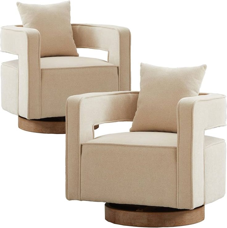 two beige chairs with pillows on them sitting side by side in front of each other