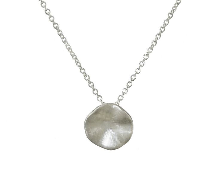 Earthy and understated, this Branch silver seed necklace is perfect for the jewelry lover who is just starting to build their collection. The slightly concave sterling silver pendant has a matte surface. It hangs from the base of a sterling silver chain. Wear this alone, or layer it with your other favorites for a personalized, eclectic look. total length : 16 1/2" : sterling silver sterling silver pendant : 3/8" diameter fastens with sterling silver spring ring clasp closure Modern Hammered Sterling Silver Necklace, Sterling Silver Coin Pendant Jewelry, Delicate Sterling Silver Round Disc Jewelry, Sterling Silver Delicate Round Disc Jewelry, Sterling Silver Round Disc Delicate Jewelry, Hammered Sterling Silver Necklaces In Silver, Silver Necklace With Large Pendant For Everyday, Hand Forged Silver Dainty Necklace, Everyday Silver Necklace With Large Pendant