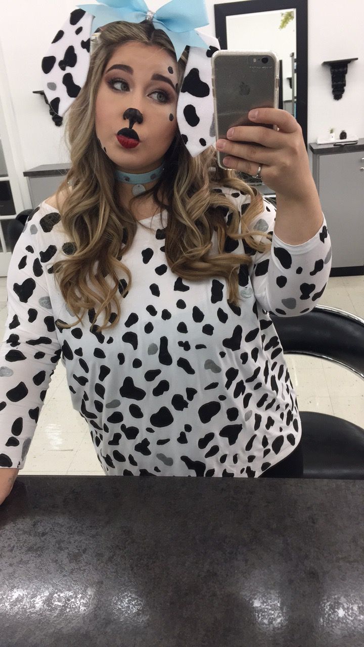 a woman in a dalmatian costume taking a selfie