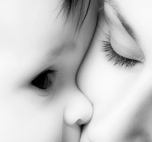 a close up of a child's face with her eyes closed and nose to the side