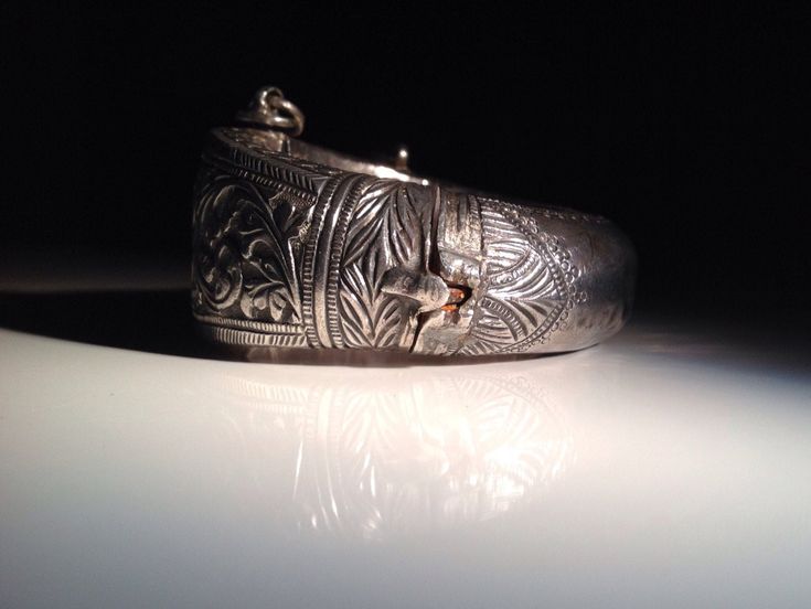 "Spectacular acanthus repousse with geometric borders. Weight is about 96 grams. A handsome example of the craftsmanship of the Indian silversmith during the time of the Raj. Condition is excellent with the heavy patina, wear, and minor dents that I like to see in an antique tribal piece. This bracelet has a small key which is inserted into an open hinge and turned to secure it. The open hinge has an iron pin (probably for strength). Dimensions: 6.75\" in circumference. No bigger wrist will fit. Traditional Engraved Sterling Silver Bracelet For Formal Occasions, Traditional Stamped Cuff Bracelet For Formal Wear, Traditional Stamped Cuff Bracelet For Formal Occasions, Antique Sterling Silver Etched Bracelet For Formal Occasions, Antique Etched Sterling Silver Bracelet For Formal Occasions, Traditional Engraved Bracelets For Formal Occasions, Carved Silver Bangle For Formal Occasions, Traditional Carved Bracelets For Formal Occasions, Traditional Hallmarked Sterling Silver Bracelet For Formal Occasions