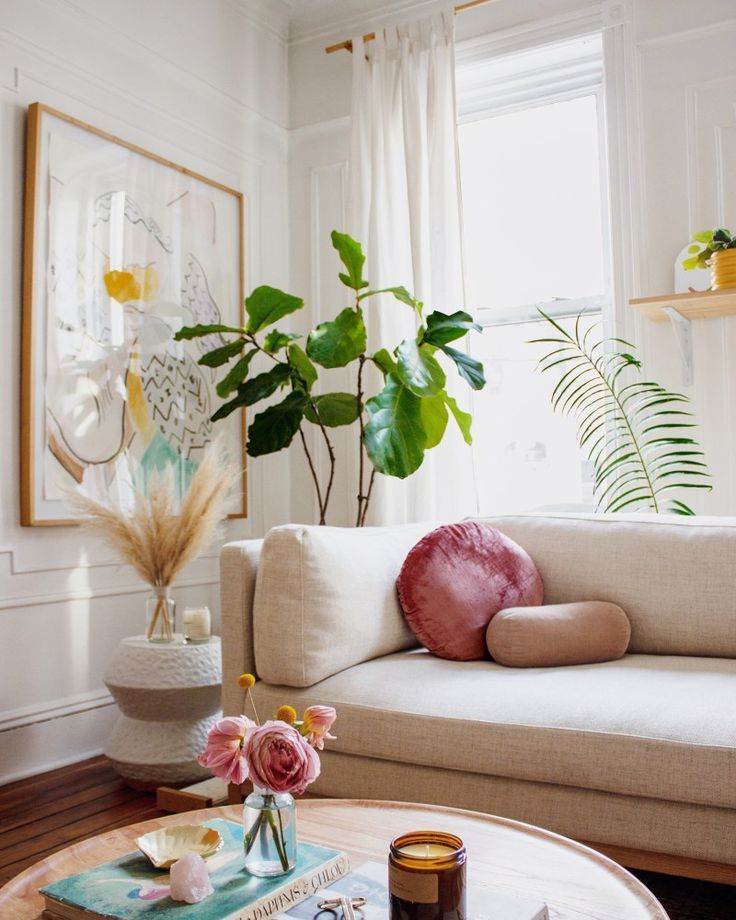 a living room with a couch, coffee table and potted plant