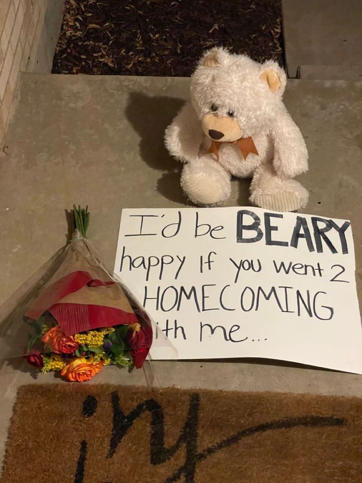 a teddy bear sitting next to a sign that says i'd be beary happy if you went 2 home coming with me