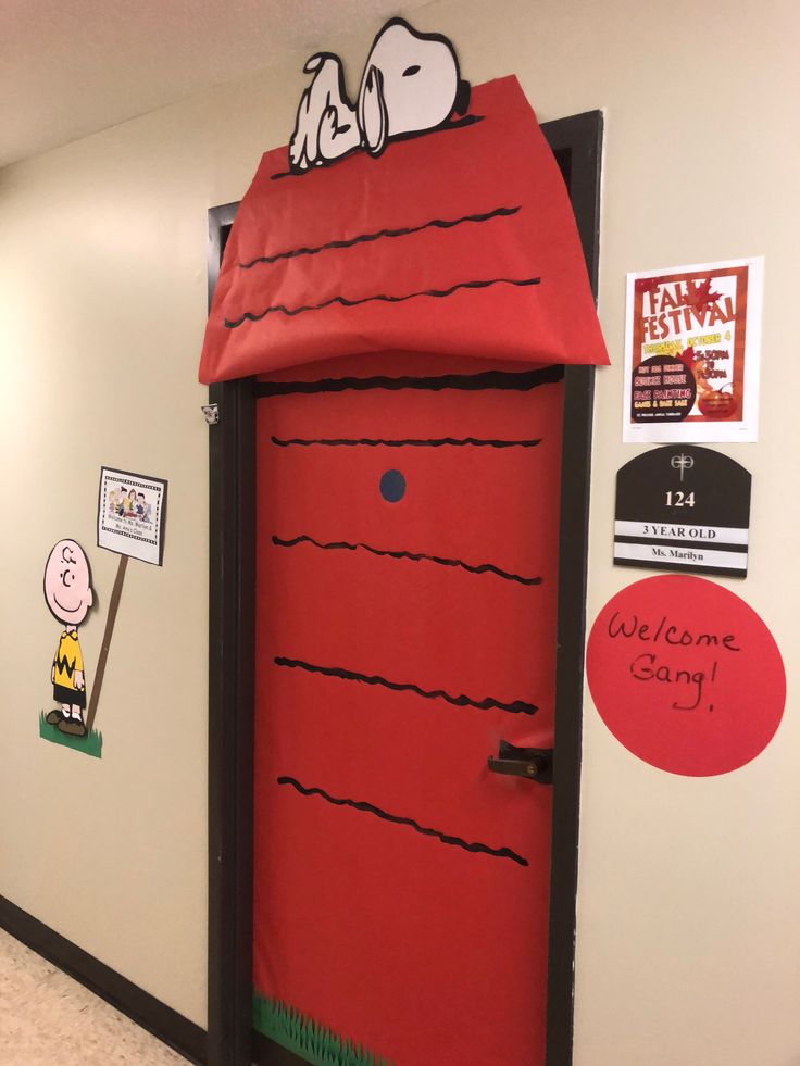 a door decorated to look like a red door with snoopy's house on it