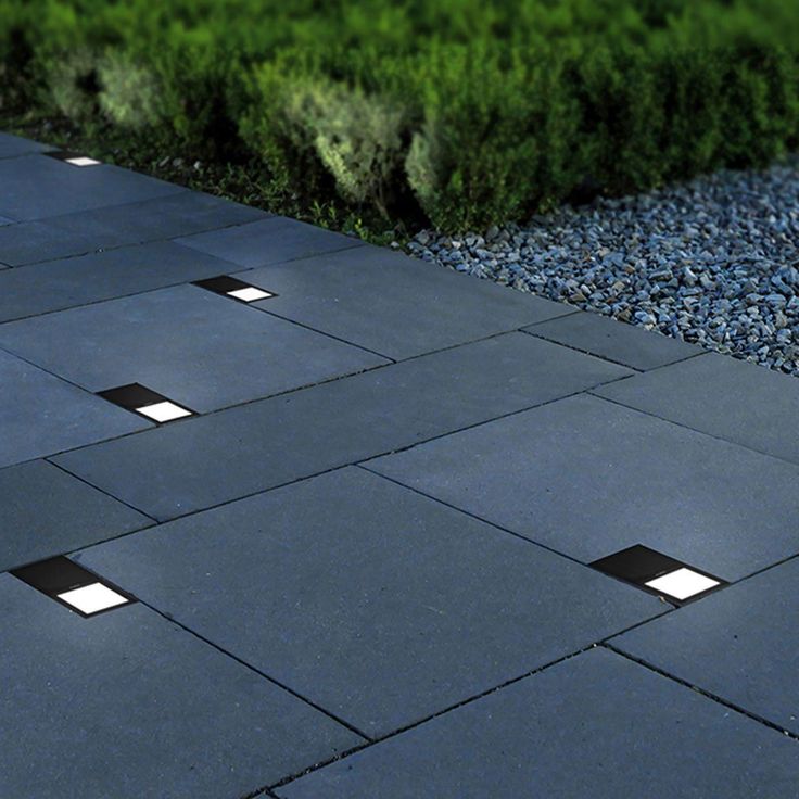 an image of a walkway that is made out of concrete blocks and has lights on it