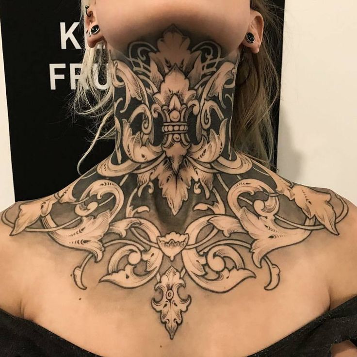 a woman with tattoos on her neck and back