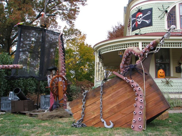 a house decorated for halloween with decorations on the front lawn