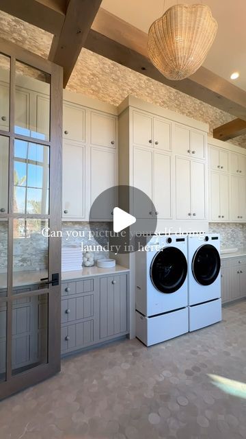 an empty laundry room with washers and dryer