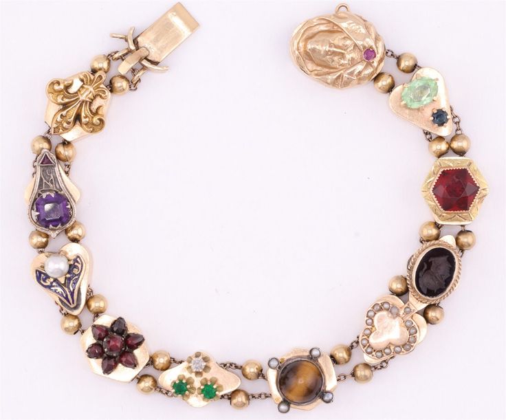 Lovely 14K yellow gold vintage slide bracelet with many different gemstones.  Diamond, ruby, seed pearl amethyst cameo, and more. 8 inches in length in the closed-clasped position.  16mm in width.  Slides are marked 14K  Guaranteed to please and ready to give. Vintage Costume Jewelry Bracelet, Victorian Bracelet With 17 Jewels For Gift, Antique Yellow Gold Multi-stone Jewelry, Heirloom Gold Multi-stone Bracelets, Antique Multi-stone Yellow Gold Jewelry, Heirloom Gold Bracelets With Multi-stone, Antique Gold Multi-stone Jewelry, Vintage Yellow Gold Cabochon Bracelets, Antique Multi-stone Gold Jewelry