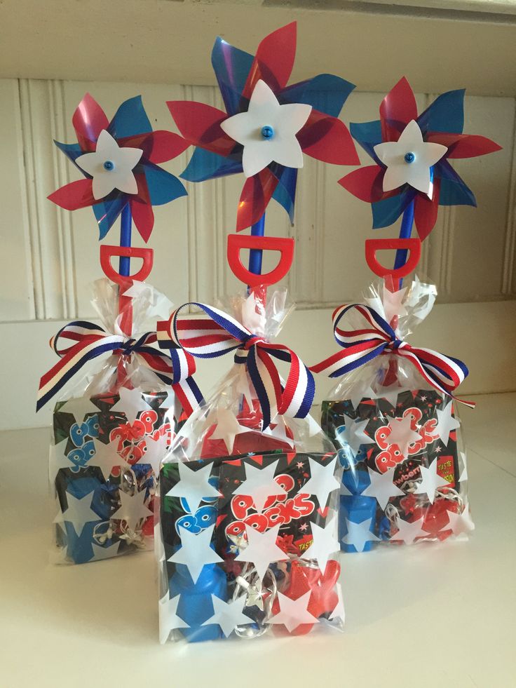 three bags with red, white and blue bows are sitting on a counter next to each other