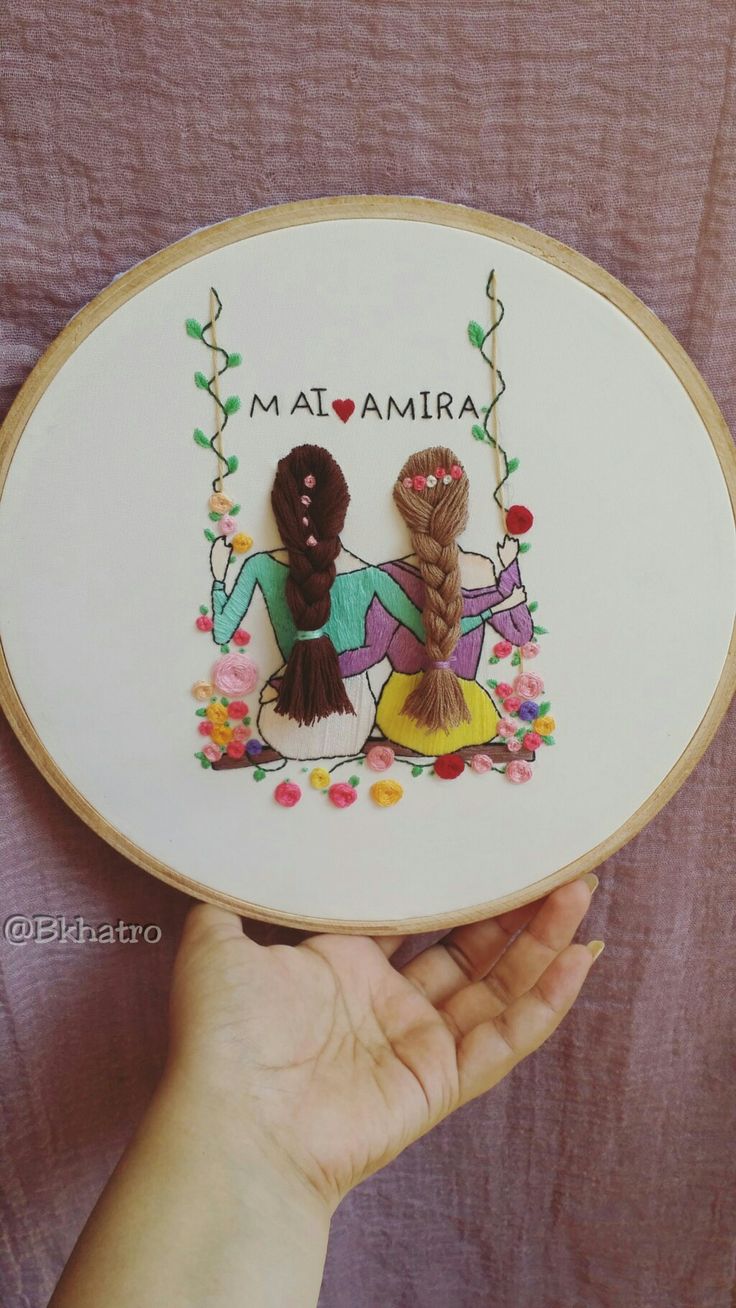 a person holding up a cross - stitched picture with the word maamara on it