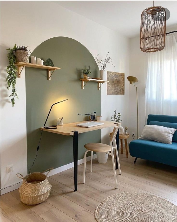 a living room filled with furniture and a blue couch in front of a green wall