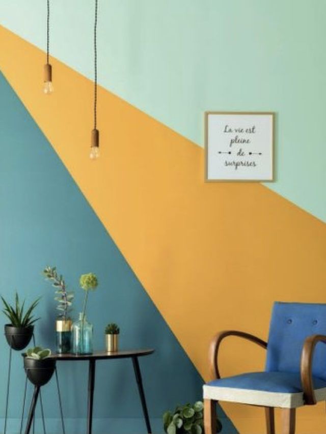 a blue chair sitting next to a table with potted plants on it