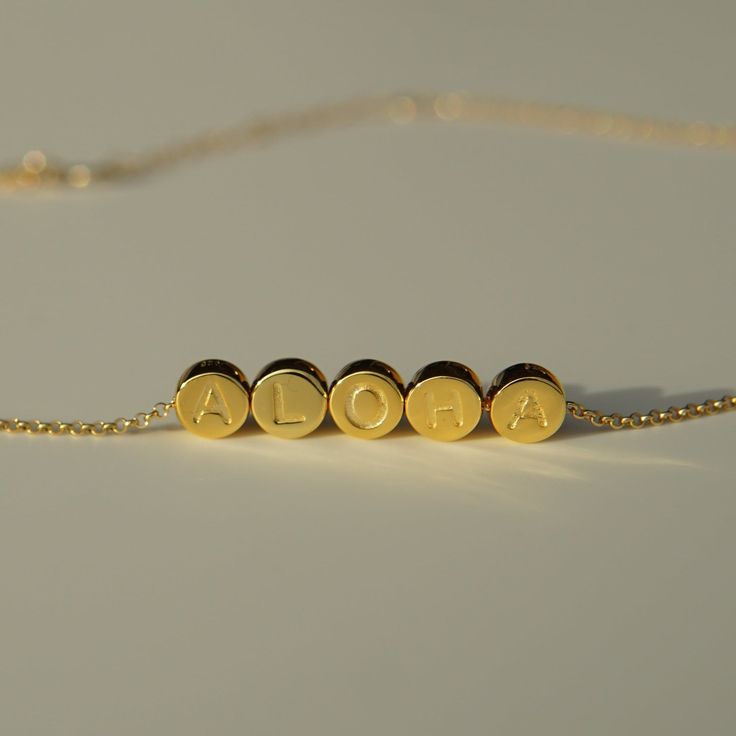 ALOHA individual beads on a dainty gold filled chain Available in an adjustable lengths 14kt gold filled chain, with vermeil pendants (sterling silver core with thick gold plating) Pendants approximately 1/4" height x 1/4" width Adjustable Gold Necklaces With Letter Beads, Gold Charm Necklaces With Letter Beads, Gold Necklace With Letter Beads For Jewelry Making, Adjustable Yellow Gold Jewelry, Adjustable Yellow Gold Jewelry For Everyday, Everyday Adjustable Yellow Gold Jewelry, Minimalist Letter Beads For Jewelry Making, Adjustable 14k Gold-filled Necklaces With Gold Beads, Adjustable Gold Minimalist Charm Necklaces