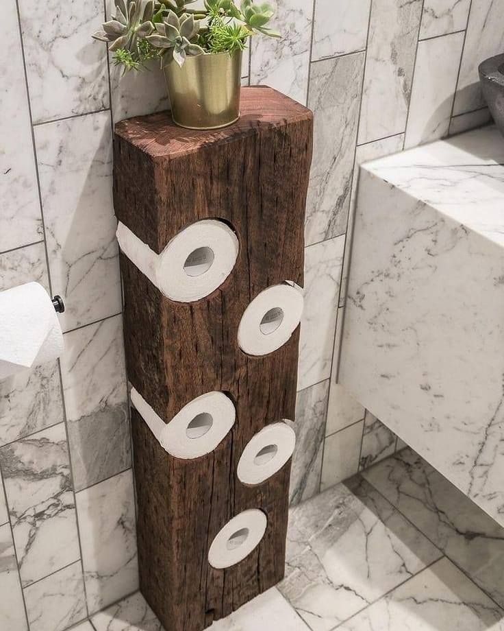 a toilet paper dispenser made out of wood