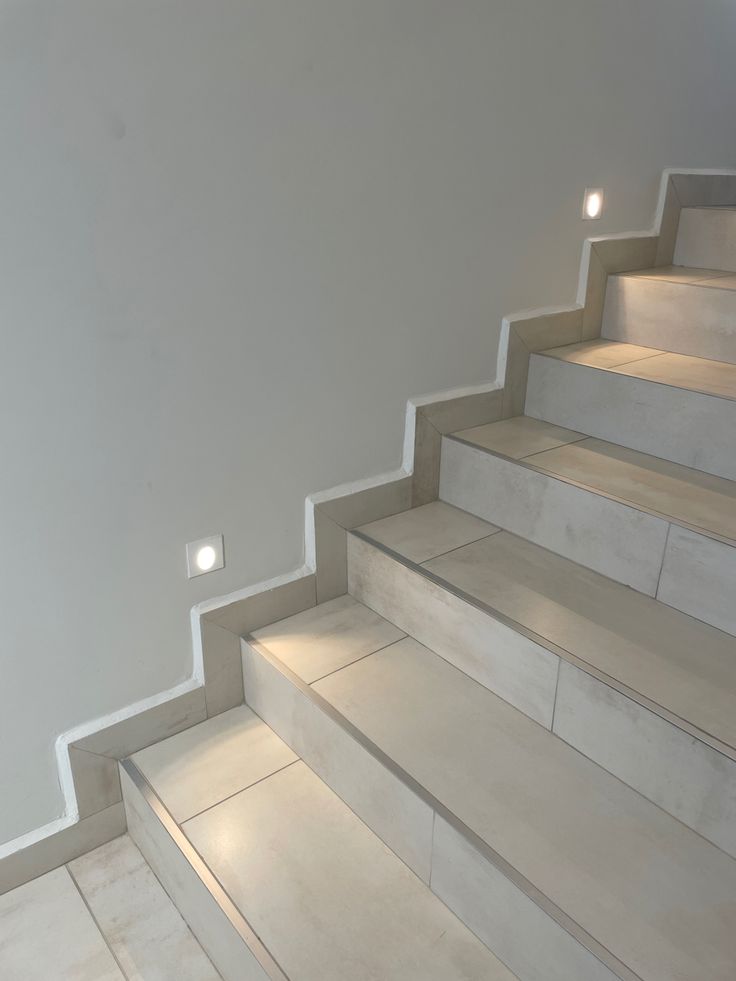 some white stairs with lights on them in a room