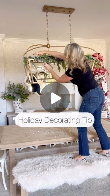 a woman standing on top of a wooden table in front of a mirror with the words holiday decor tips