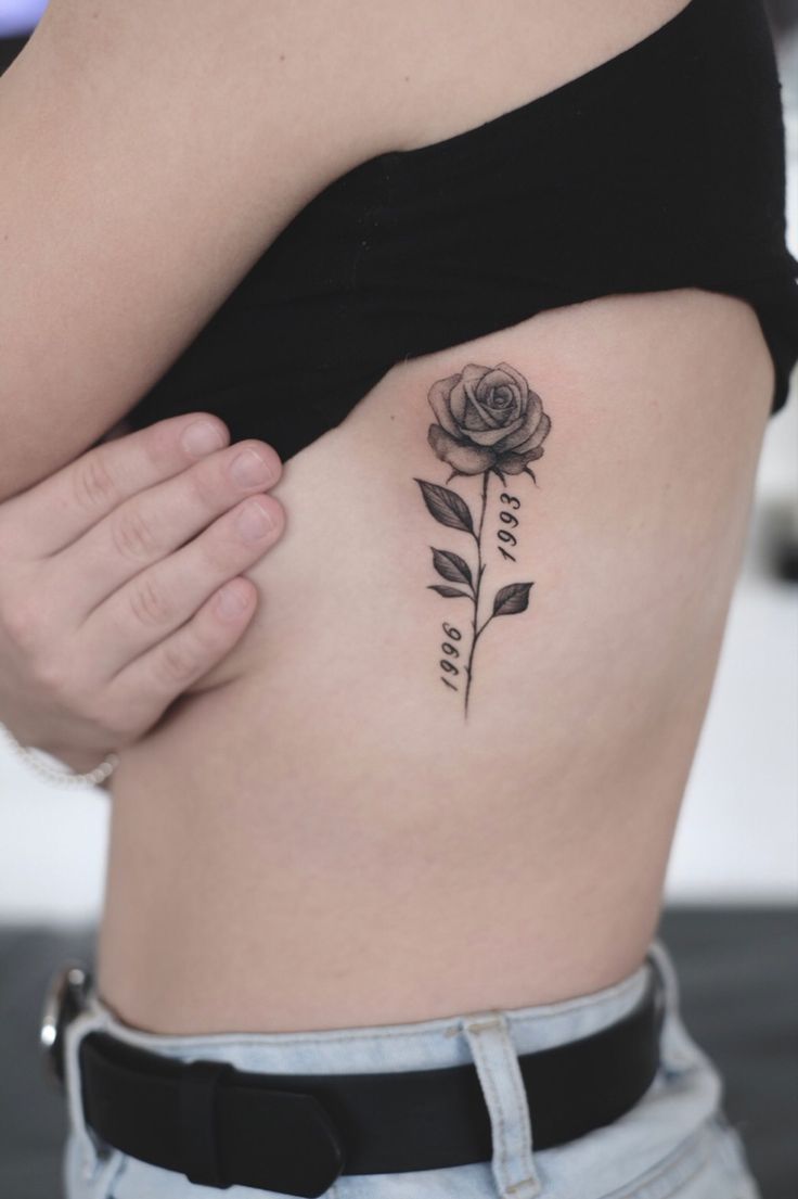 a woman with a rose tattoo on her stomach