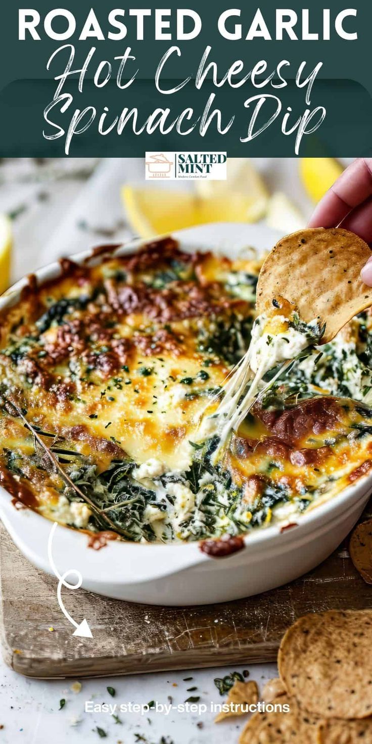 a hand holding a tortilla chip with cheese and spinach dip