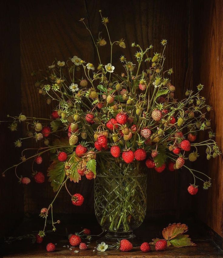 a vase filled with lots of flowers on top of a table