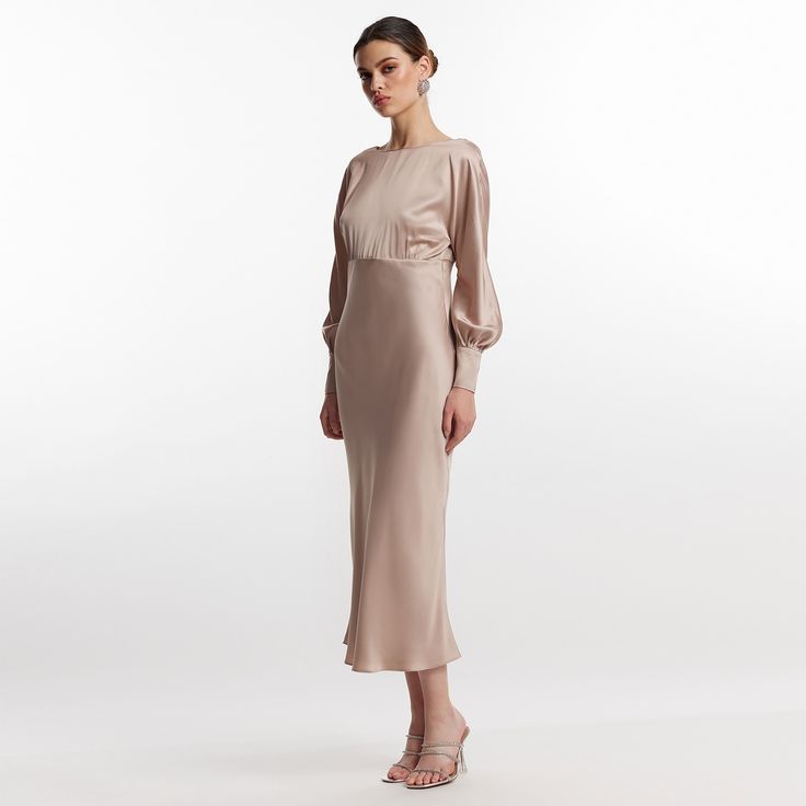 The elegant beige Lily backless dress exudes bold and elegant charm.  It is made of a mixture of silk and viscose with a satin appearance. The dress has long lilac sleeves, a boat neckline and a bare back for a sensual but also refined look 60% silk 40% viscose dry clean Luxury Satin Maxi Dress For Dinner, Silk Midi Dress With Fitted Bodice In Sheath Style, Silk Sheath Midi Dress With Fitted Bodice, Satin Sheath Maxi Dress For Evening, Silk Midi Dress For Dinner, Elegant Sheath Slip Dress For Formal Occasions, Elegant Backless Satin Dress Midi Length, Elegant Satin Backless Midi Dress, Sleek Silk Dress With Back Opening