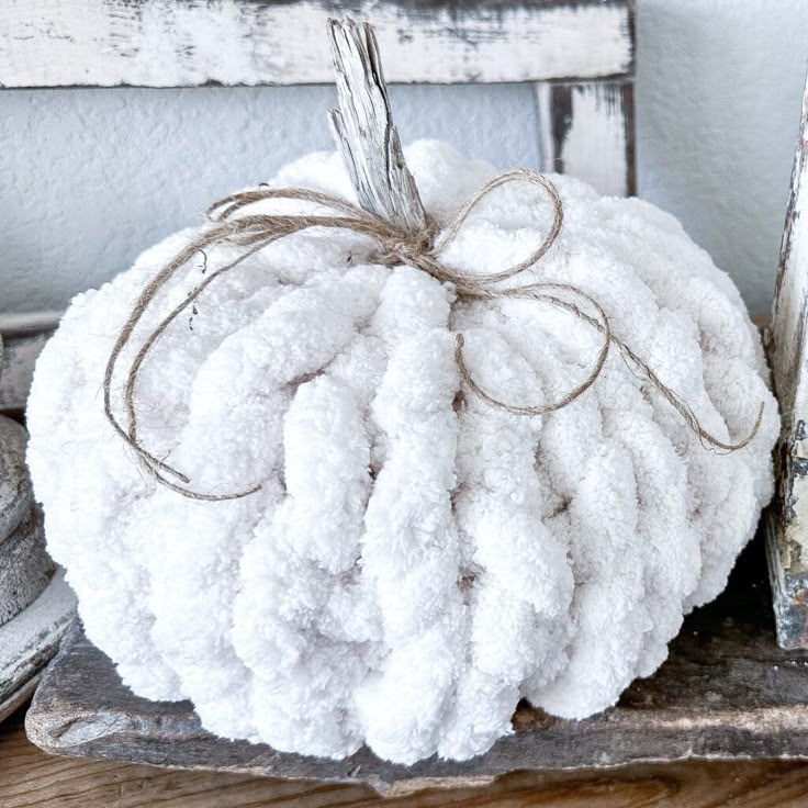 a white pumpkin sitting on top of a wooden tray