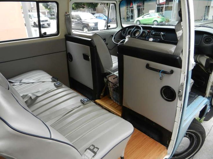 the interior of an old car with leather seats and wood flooring on the street