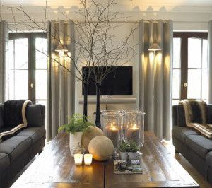 a living room with two couches and a coffee table in front of a flat screen tv