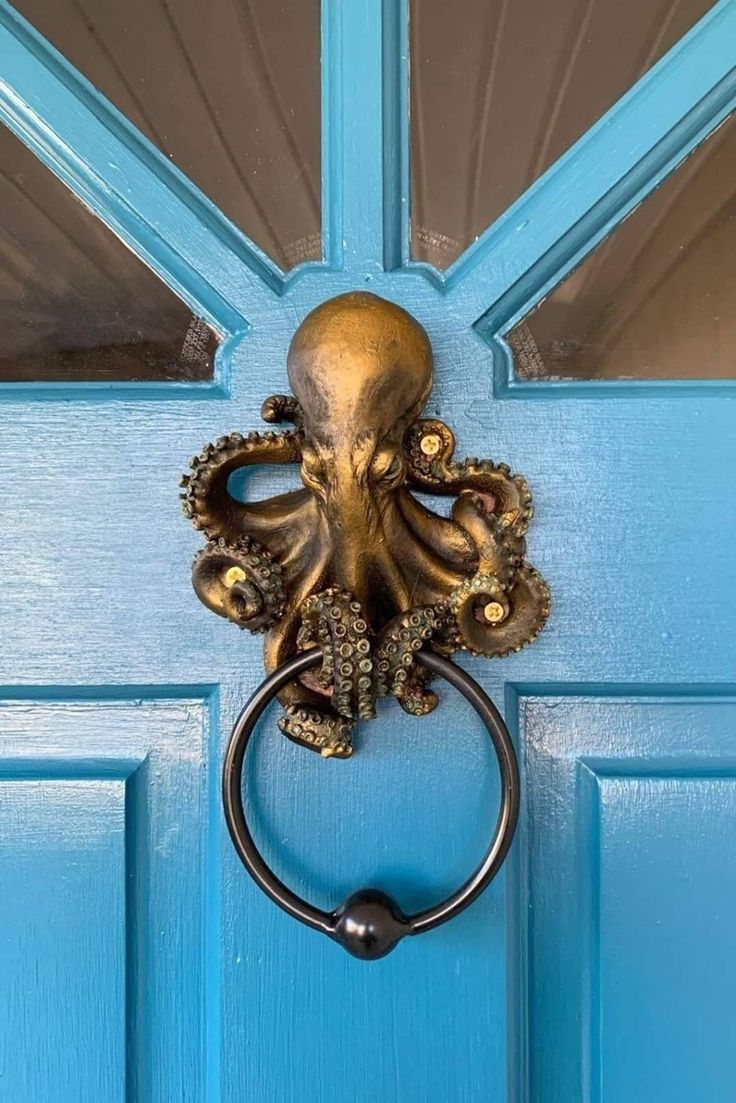 an octopus door knocker on a blue door