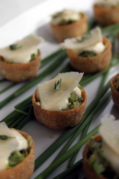 small appetizers are topped with cheese and green onions