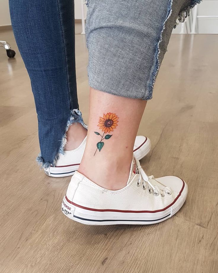 a woman with a sunflower tattoo on her ankle