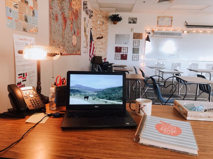 an open laptop computer sitting on top of a wooden desk