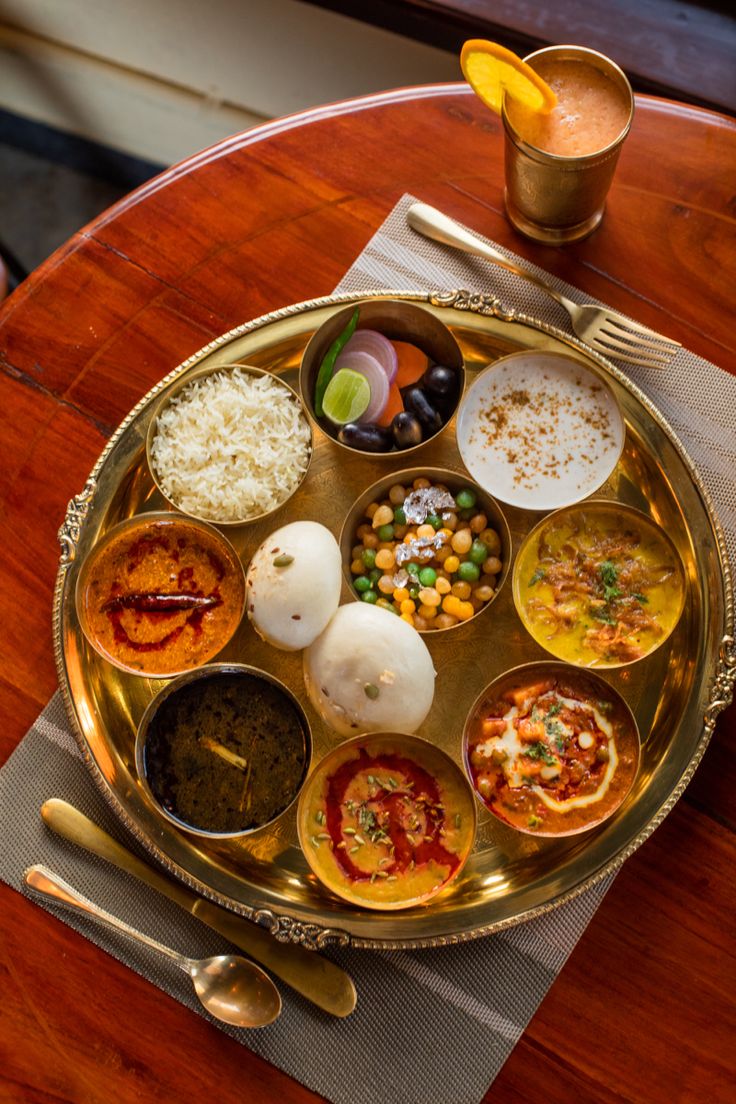 a plate with different types of food on it sitting on top of a wooden table