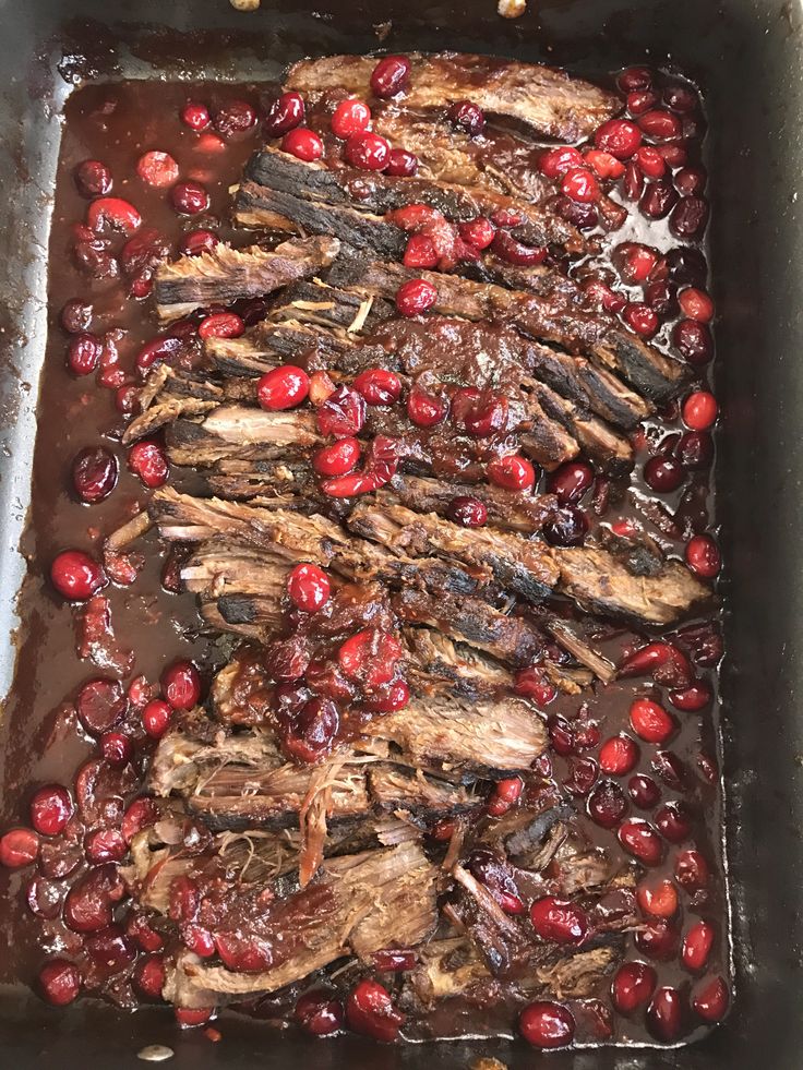 meat and cranberry sauce in a roasting pan