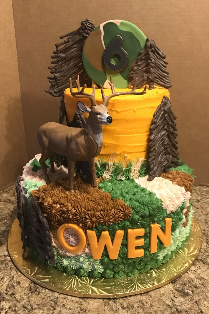 there is a cake decorated with deer and trees