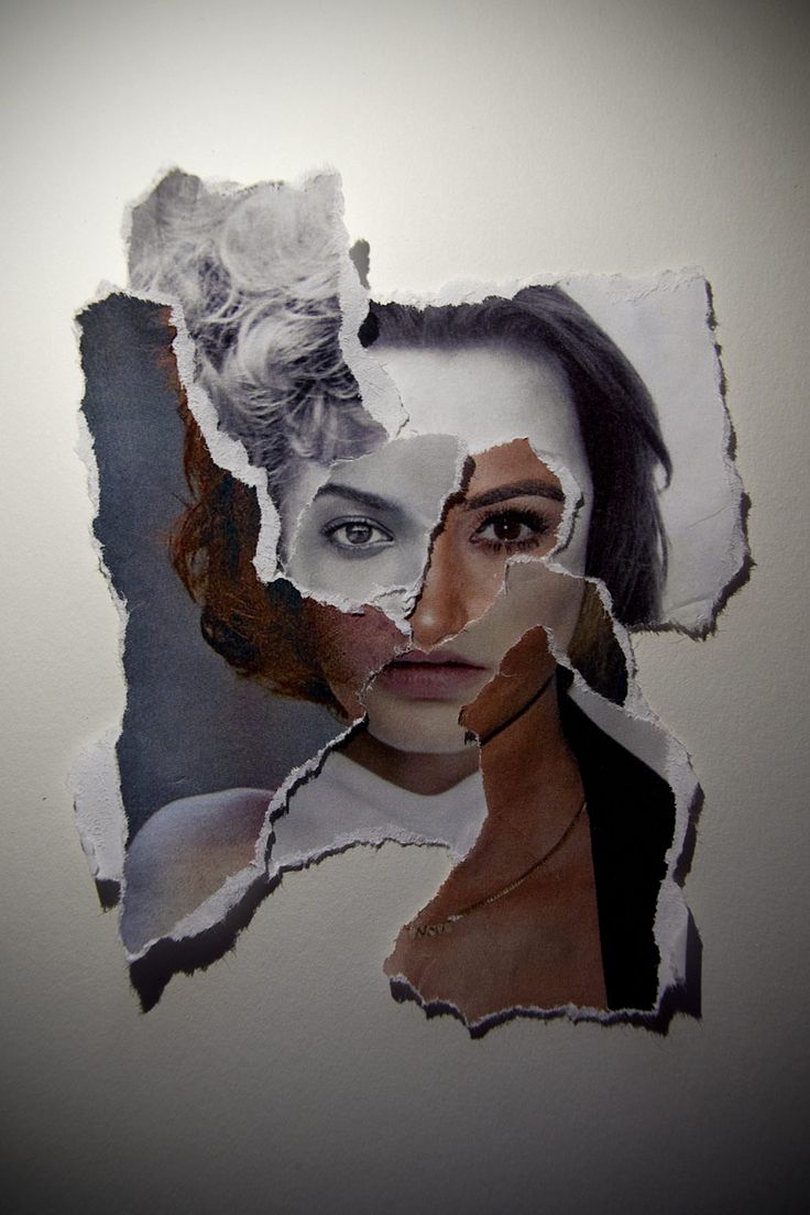 a woman's face is shown through torn pieces of paper that have been placed on the wall