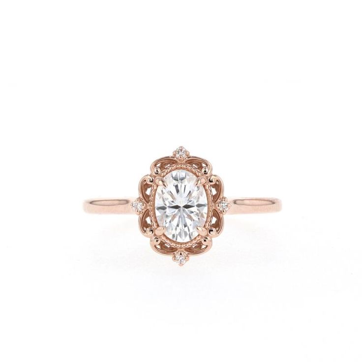 an antique style engagement ring with a round center stone in rose gold and white diamonds