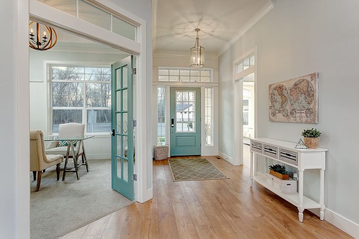 an open door leading into a living room with hardwood floors and blue doors on either side