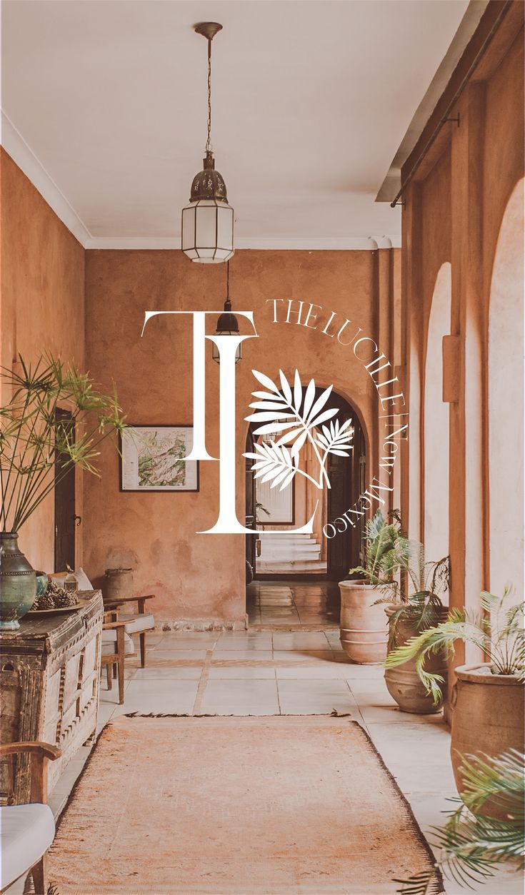 the entrance to an elegant house with potted plants