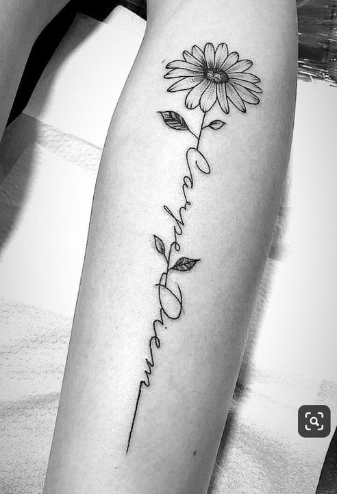 a woman's arm with a flower and the words love written in cursive writing