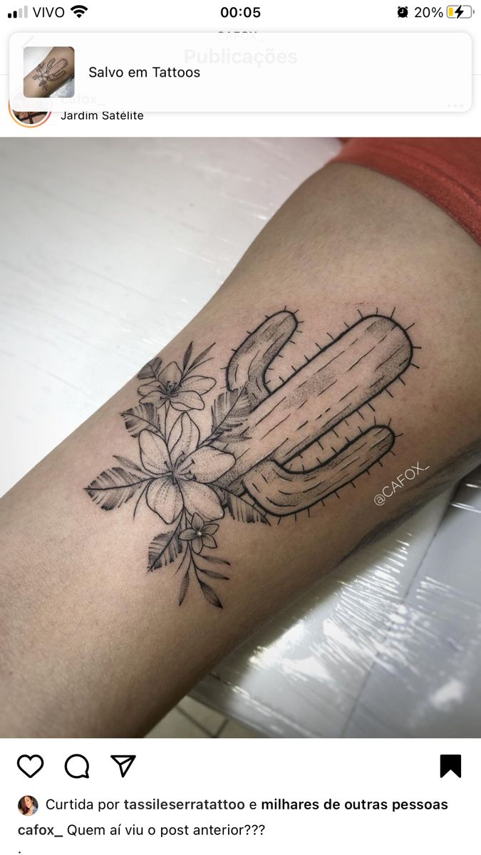 a person with a tattoo on their arm that has scissors and flowers in the middle