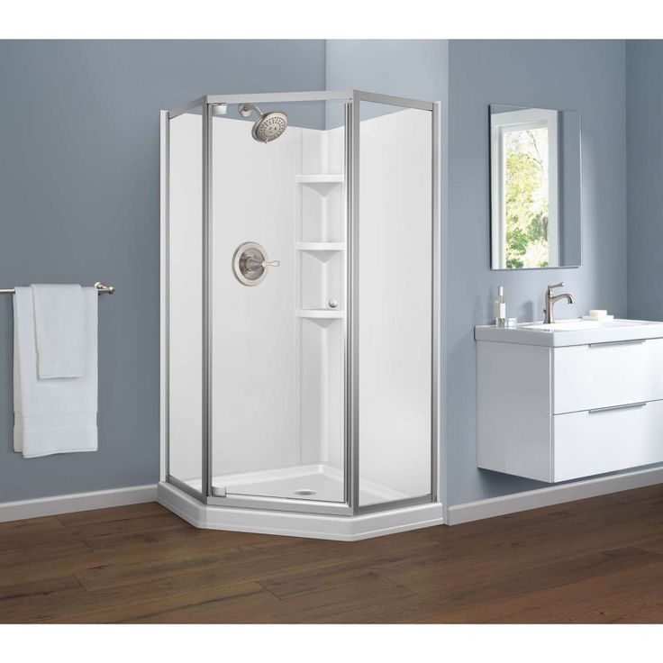 a white bathroom with a stand up shower