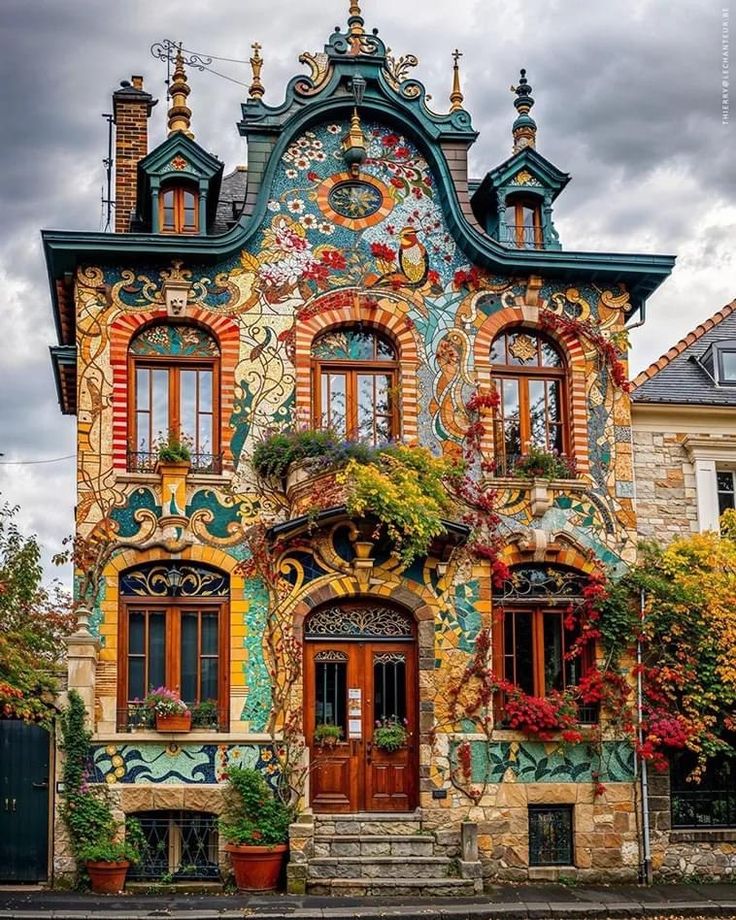 an ornate building with lots of windows and flowers on it