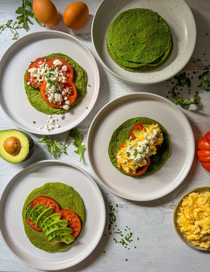 four plates with different types of food on them and one has an avocado