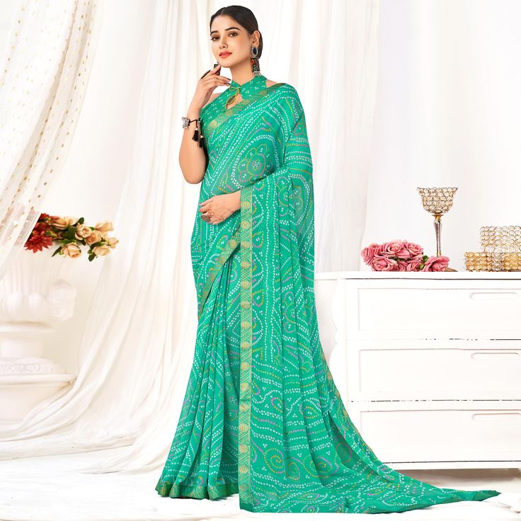 Sea Green colored saree is made from chiffon fabric which is highlighted with beautiful bandhani printed work as shown. Comes along with unstitched chiffon blouse piece which you can customise as per your design/style. Occasion - You can wear this saree for casual and daily wear. Note:- the actual product may differ slightly in color and design from the one illustrated in the images when compared with computer or mobile screen. Measurements: Saree : Chiffon : 5.5 Mtrs Blouse : Chiffon : 0.8 Mtr Material: Chiffon Stitch Type: Unstitched Country of Origin: India Care Guide: Dry Clean Printed Chiffon Saree, Saree Chiffon, Blouse Chiffon, Mobile Screen, Silk Lehenga, Chiffon Saree, Chiffon Blouse, Sea Green, Print Chiffon